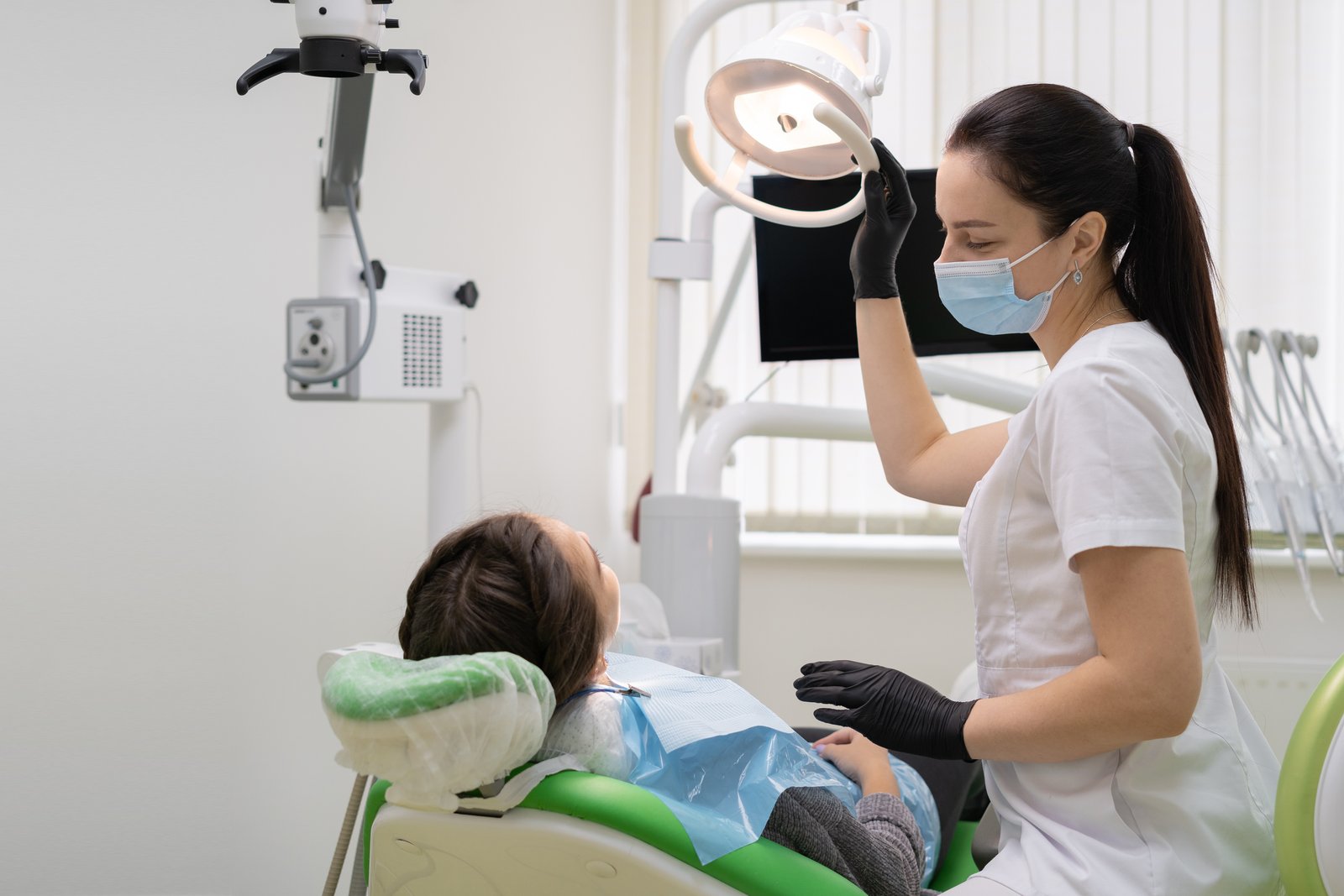 Dentist treating a patient during a full-arch dental implant consultation